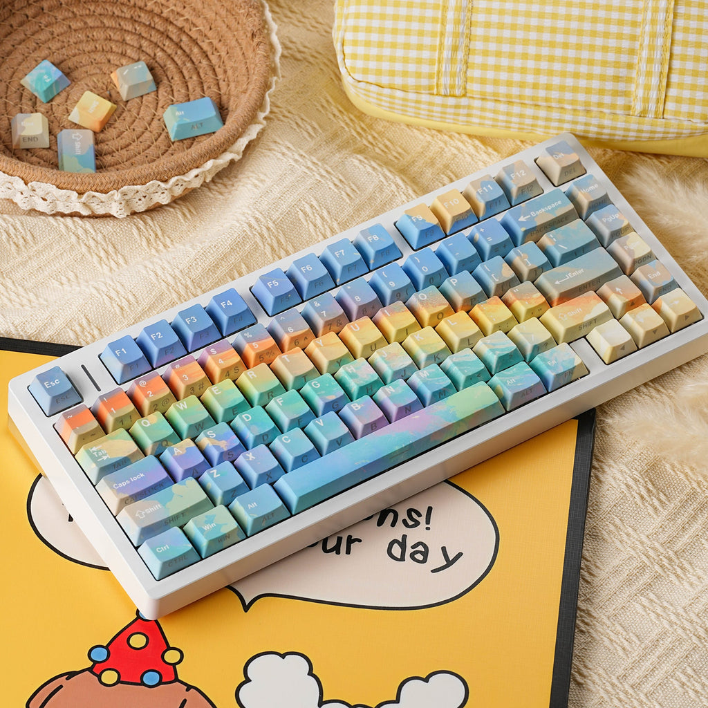 Rainbow keycap set — styled scene with props